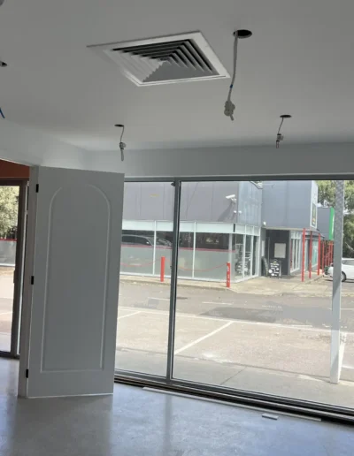 Commercial painting project completed by Power Brush Painting, featuring freshly painted walls and finishes in a retail fit-out space.